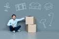 Emotional man sitting on the floor after moving to an empty house Royalty Free Stock Photo