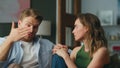 Emotional man telling story to wife home closeup. Serious lovers talking sofa Royalty Free Stock Photo
