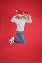 Emotional man with vintage radio jumping on red background. Christmas music Royalty Free Stock Photo