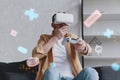 Emotional man in VR glasses playing video game with joystick, innovation hologram Royalty Free Stock Photo