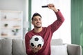 Emotional middle-eastern man watching football match on TV Royalty Free Stock Photo