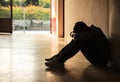 Emotional moment: man sitting holding head low on knees, stressed sad young male having mental problems, feeling bad, depressed Royalty Free Stock Photo