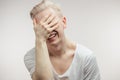 Emotional overjoyed Albino male model grabbing his face can not help laughing Royalty Free Stock Photo