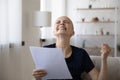 Overjoyed young bald woman getting letter with amazing news.
