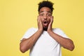 Emotional and People Concept - Portrait of excited young African American man screaming in shock and amazement holding