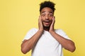 Emotional and People Concept - Portrait of excited young African American man screaming in shock and amazement holding