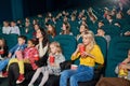 Emotional people watching film in the new cinema. Royalty Free Stock Photo