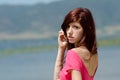 Emotional picture of a cute lady near a lake