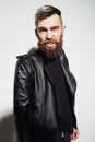 Emotional portrait of a bearded young man in a leather jacket