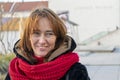 Emotional portrait of a cheerful 40-45 year old woman with red hair.