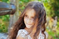 Emotional portrait of a little girl with long hair, summer day