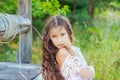 Emotional portrait of a little girl with long hair, summer day