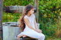 Emotional portrait of a little girl with long hair, summer day