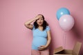 Emotional surprised woman feeling shock at gender party, expecting twins boy and girl, holding head and touching belly Royalty Free Stock Photo