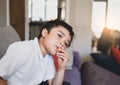 Emotional portrait young boy looking out deep in thought while eating nut, Cinematic portrait Child sitting alone with thinking Royalty Free Stock Photo