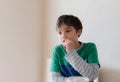 Emotional portrait young boy looking out deep in thought while eating nut, Cinematic portrait Child sitting alone with thinking Royalty Free Stock Photo