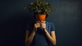 Emotional Portraits: Woman With Potted Plant In Strong Negative Space