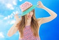 Emotional positive girl in hat and summer dress posing isolated