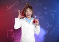 Emotional pupil holding conical flask against blackboard with chemistry formulas Royalty Free Stock Photo