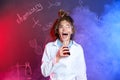 Emotional pupil holding conical flask in smoke with chemistry formulas Royalty Free Stock Photo