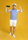 Emotional sailor with binoculars on yellow background