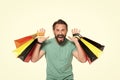 Emotional Extremely happy man with colored shopping bag in hands on white background. Attractive man holds shopping bags in two Royalty Free Stock Photo