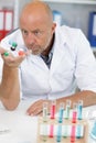 emotional scientist working in modern lab with model Royalty Free Stock Photo