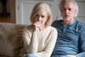 Emotional senior couple get nervous watching TV drama at home