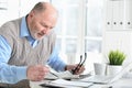 Emotional senior man reading newspaper at home Royalty Free Stock Photo