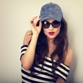 Emotional young woman in sunglasses and blue baseball cap p Royalty Free Stock Photo