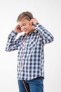 Emotional singer blonde boy in a plaid shirt with headphones