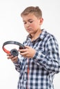 Emotional singer blonde boy in a plaid shirt with headphones Royalty Free Stock Photo