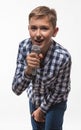 Emotional singer blonde boy in a plaid shirt with a microphone and headphones Royalty Free Stock Photo