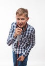 Emotional singer blonde boy in a plaid shirt with a microphone and headphones Royalty Free Stock Photo