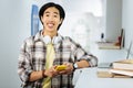 Emotional student holding a smartphone while visiting a coworking space