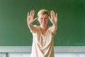 Emotional teacher signalling a stop with hands