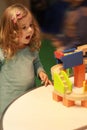 Emotional toddler girl excited of the basics of physics and mechanics at the nursery