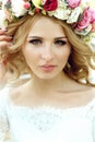 Emotional touched beautiful blonde bride in white dress in wreath with make-up close-up Royalty Free Stock Photo