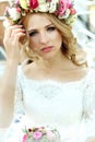 Emotional touched beautiful blonde bride in white dress in wreath with make-up close-up Royalty Free Stock Photo