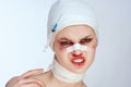 emotional woman bandaged face the syringe sticks out in the head light background