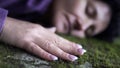 Emotional woman resting on the nature hand touching the stone moss