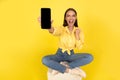 Emotional Woman Showing Cellphone Empty Screen Shaking Fist, Yellow Background Royalty Free Stock Photo