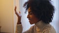 Emotional woman talking home close up. Curly hair positive lady gesturing hand