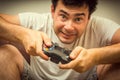 Emotional young addicted man playing video games