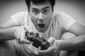 Emotional young addicted man playing video games Royalty Free Stock Photo