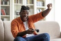 Emotional young black man playing video games at home Royalty Free Stock Photo