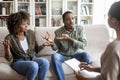 Emotional black spouses fighting in front of family therapist Royalty Free Stock Photo