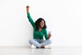 Emotional black woman gambling online, using cellphone Royalty Free Stock Photo