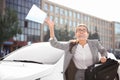 Emotional young businesswoman with documents in hurry to work