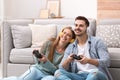 Emotional young couple playing video games Royalty Free Stock Photo